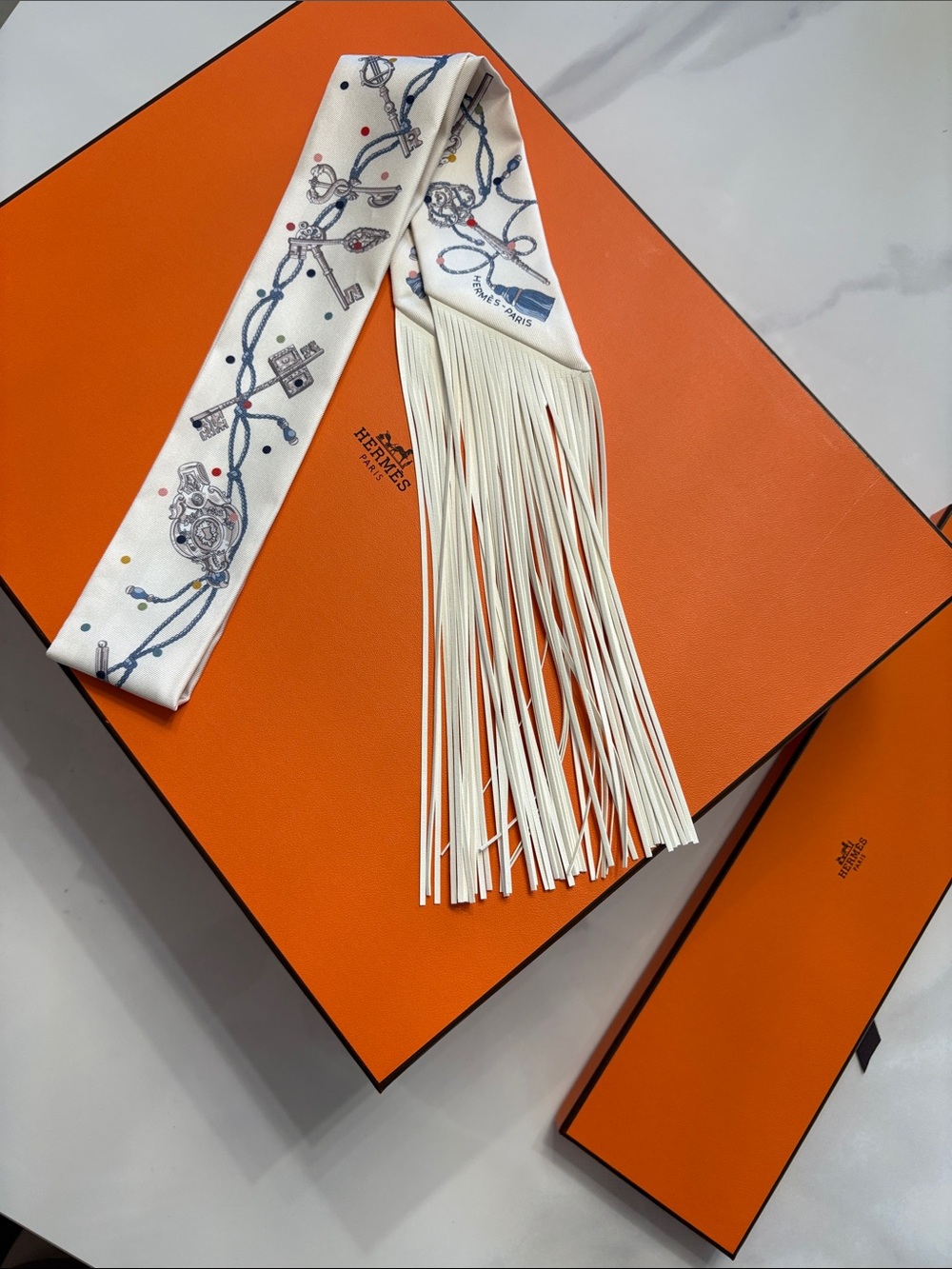 Hermes Ivory Silk Twilly with Blue Chain Print and Leather Fringe